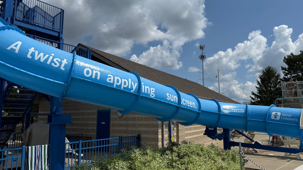 Cut-out vinyl graphic installed on the exterior curve of the Beachwood Family Aquatic Center waterslide.