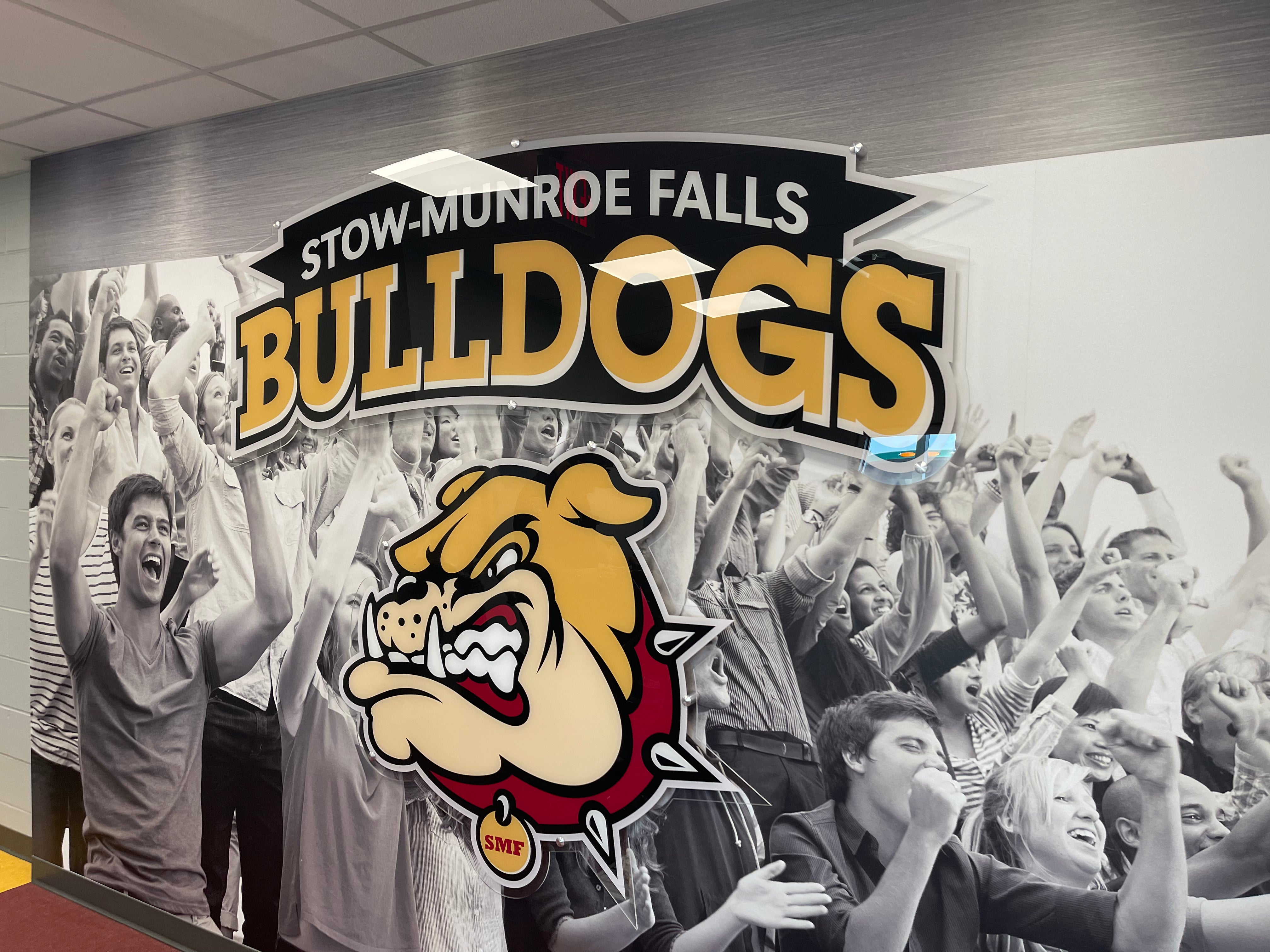 Smooth Wall sticker graphics with a contour cut clear acrylic graphic with aluminum stand-offs. Printed using white ink at Stow-Munroe Falls High School Field House in Stow, OH