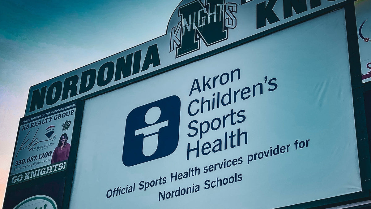 Large-format outdoor stadium 13 oz vinyl banner and athletic scoreboard graphics for Akron Children's Hospital branding. Nordonia High School- Macedonia, OH