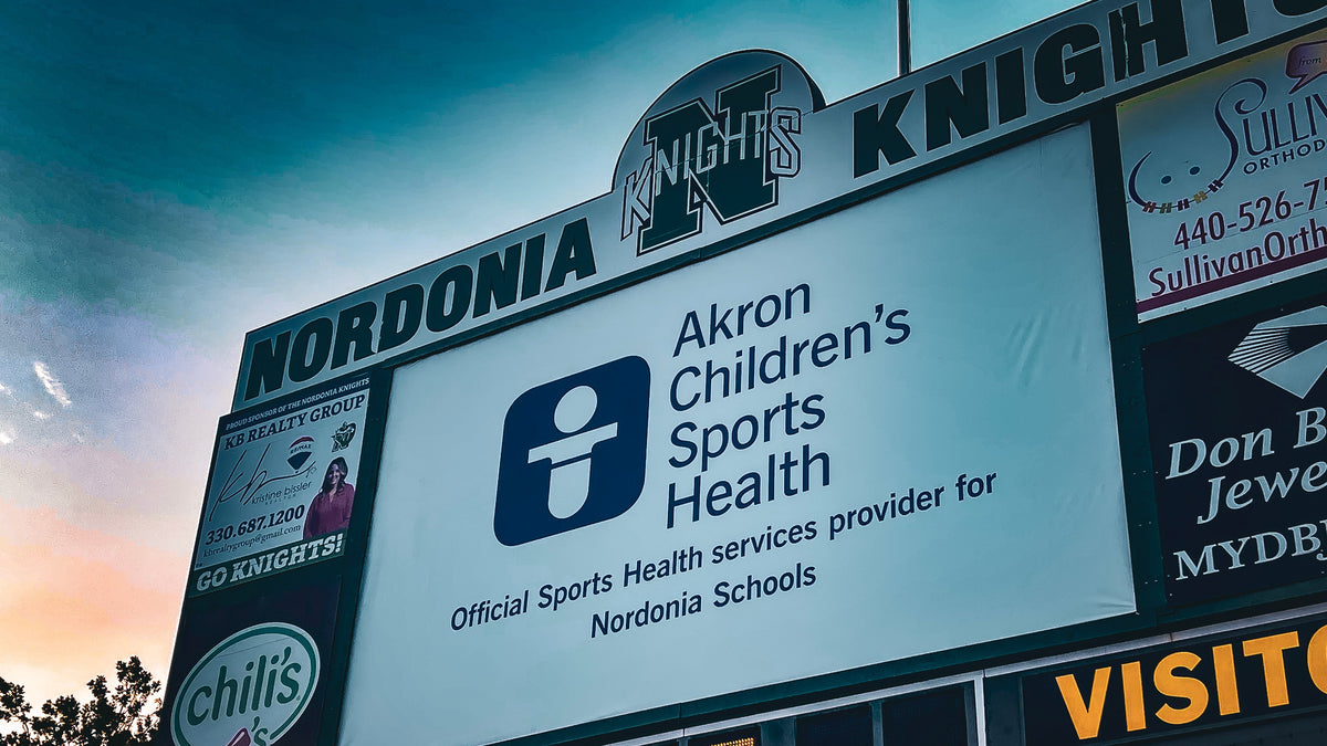 Massive 13oz Backlit Banner installed to scoreboard for Akron Children's Hospital as the official Sports Health services provide for Nordonia Schools in Macedonia, OH