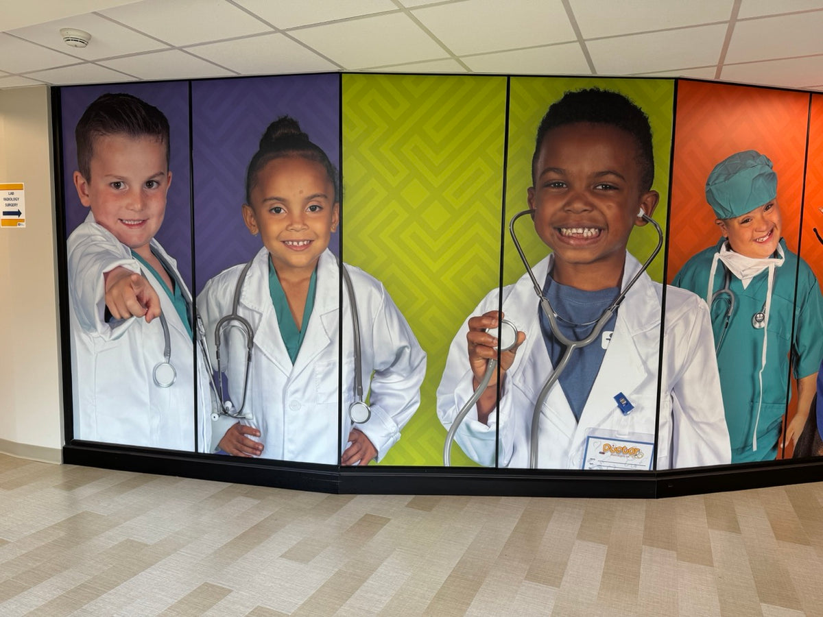 A large wall mural installed by DG Creativ using vinyl graphics on a glass wall at Akron Children's facility in Boardman, OH