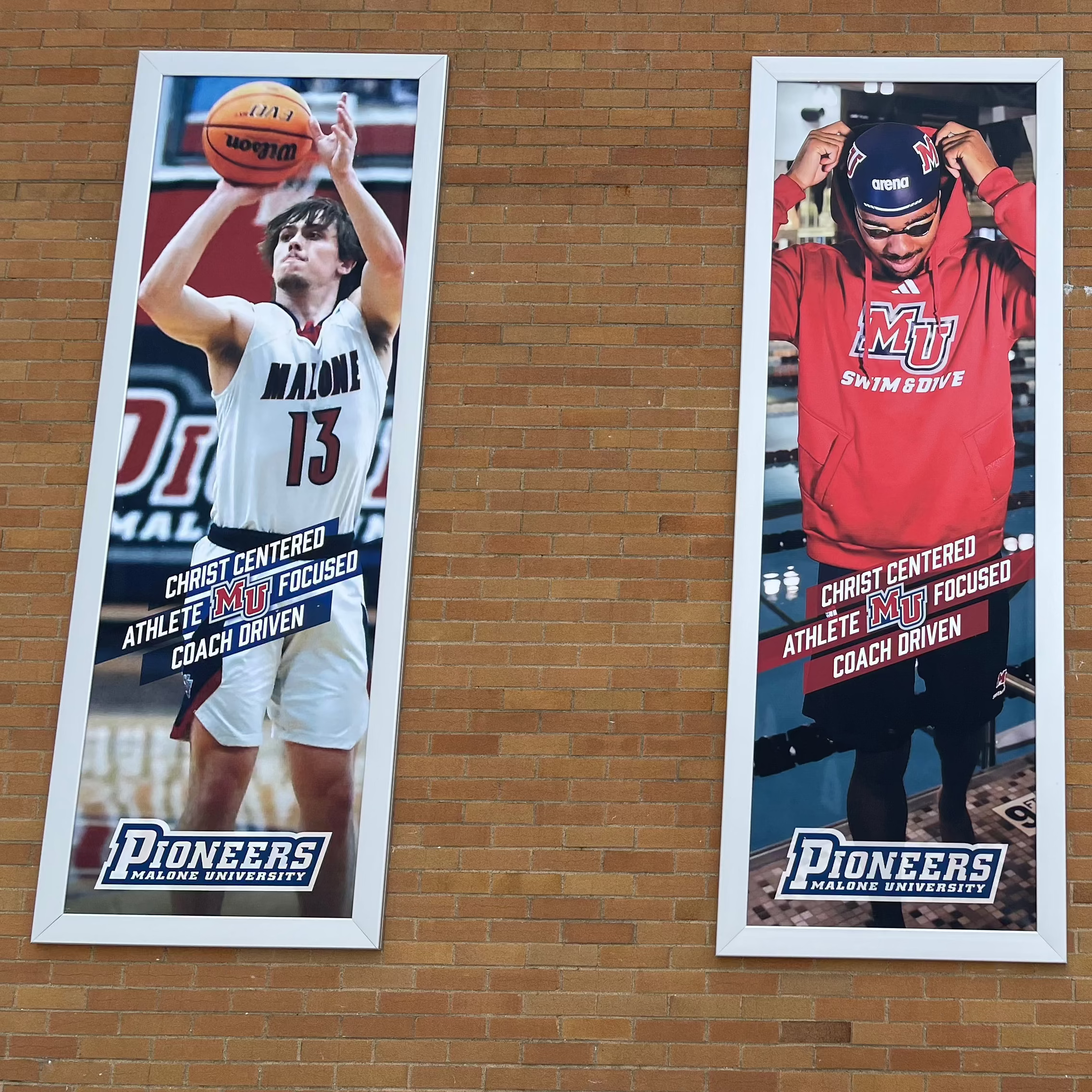 CreativStretch wall-mounted aluminum banner frame system for stadium murals at Malone University in Canton, OH