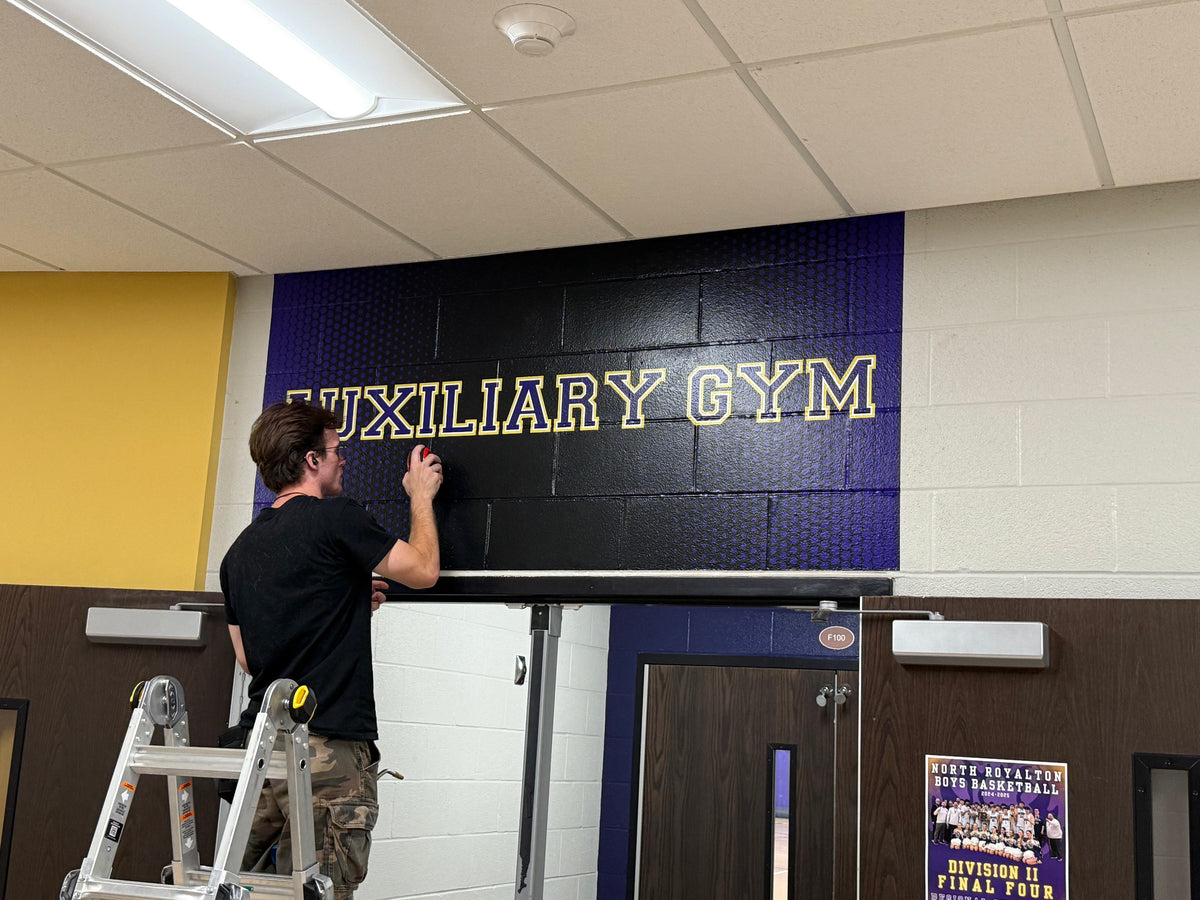 Textured BrickWrap graphics for athletic facility hallway and locker room identification