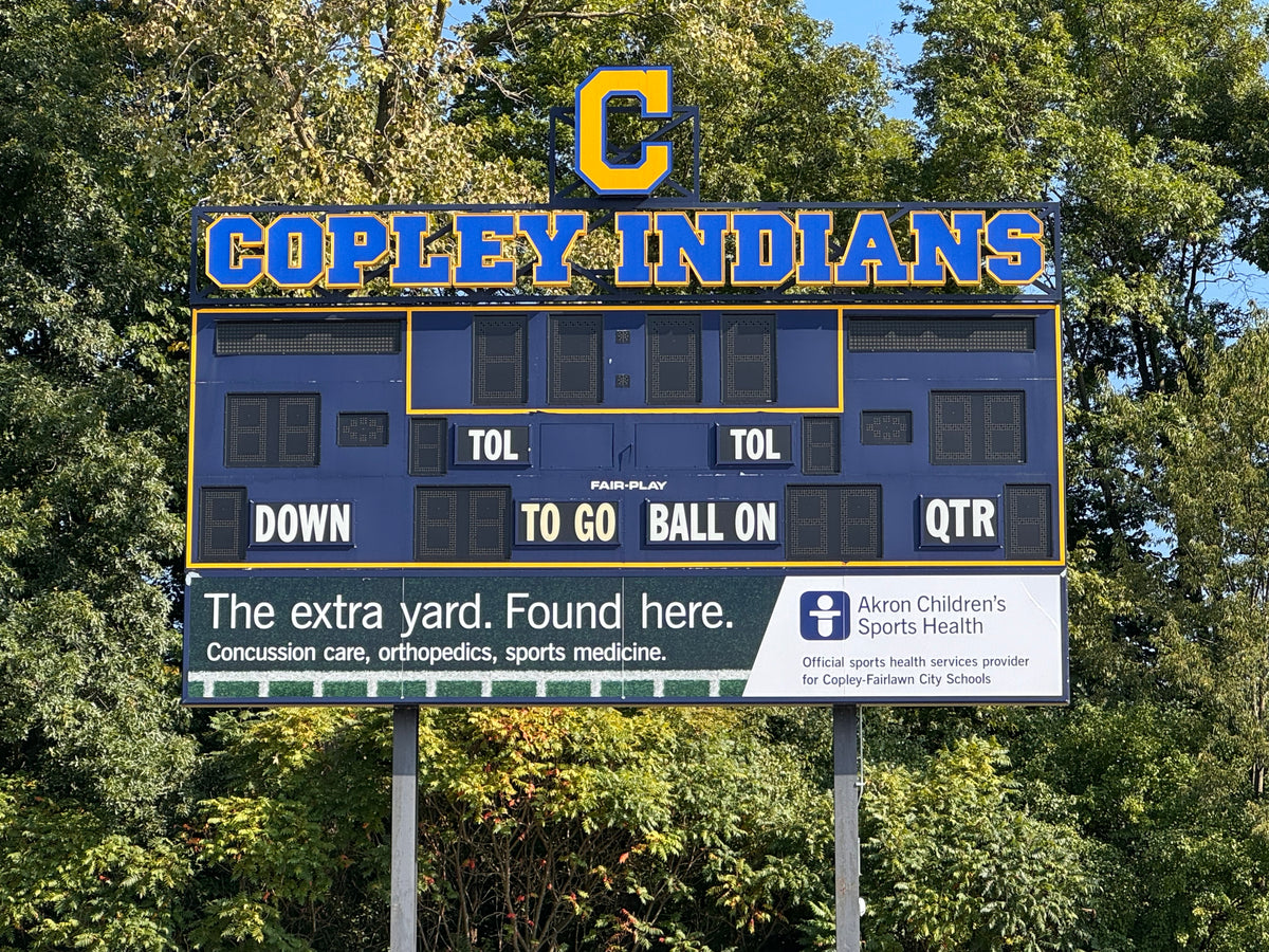 Backlit self-adhesive vinyl (SAV) graphics on acrylic panels for Copley High School scoreboard